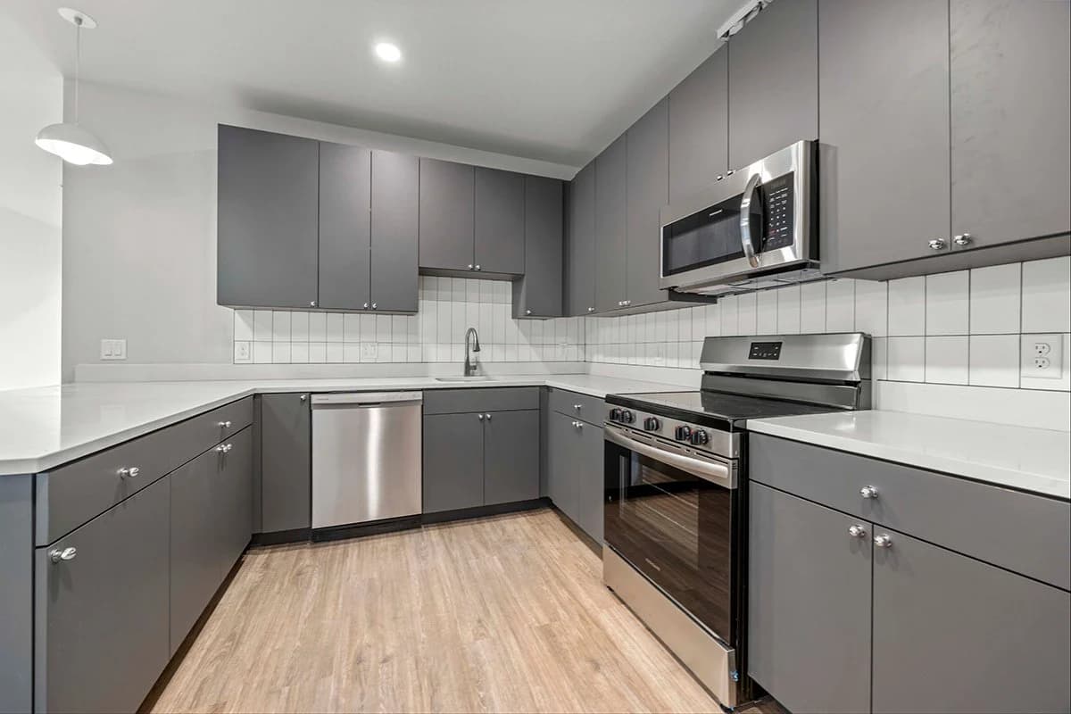 Luxury kitchen with quartz countertops and stainless appliances in a West Denver area apartment